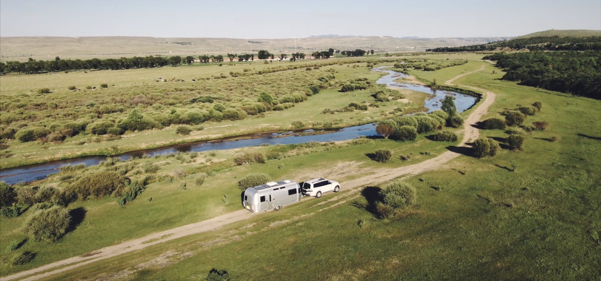An RV crossing grassland (aerial)